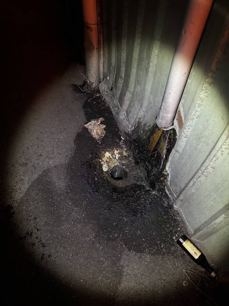 黄姓女大生赶公车鞋子误入排水孔掉了，杨梅警靠2物巧手救鞋。（警方提供）