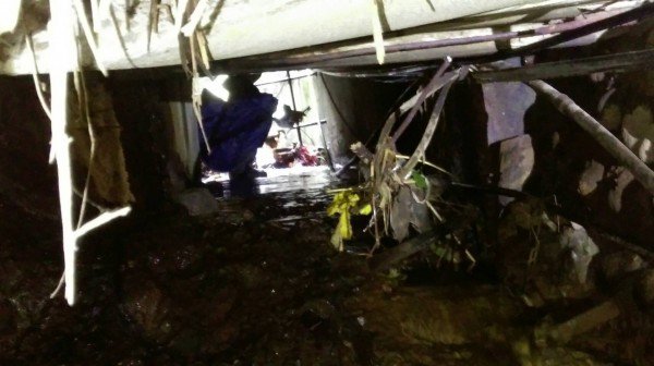 警察与环保人员爬入涵洞采集废水。（记者张瑞桢翻摄）